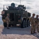 Photo: US Army soldiers are outside a Stryker armored infantry