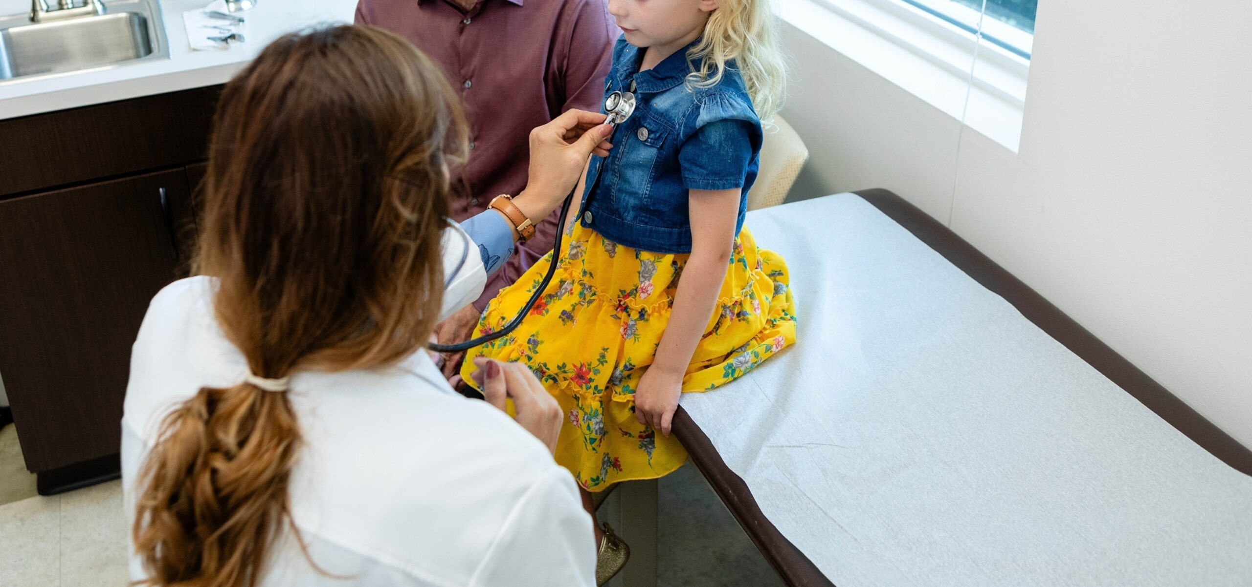 Photo: A doctor reviews a child in an office in a file photo without date. 