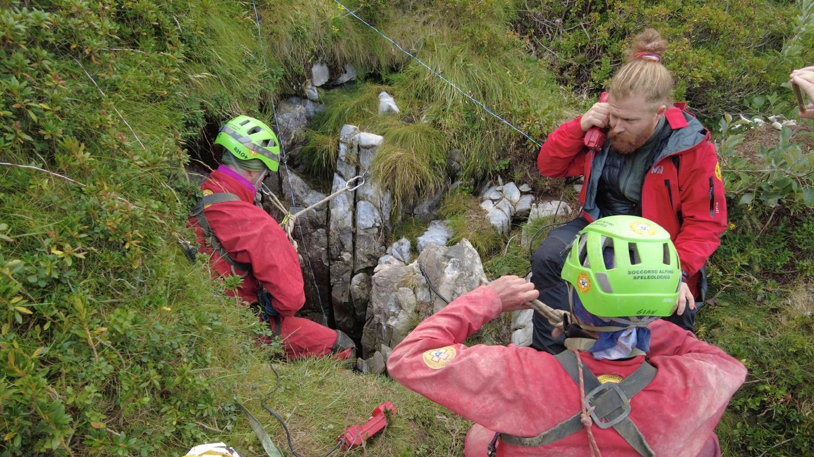 Rescuers work to free an injured cave explorer trapped more than 130 feet underground in Italy