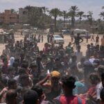 Photos show Palestinians pursuing food aid after the latest air drops in Gaza