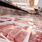 PHOTO: Low angle view of a variety of meat packed on trays in the supermarket freezer